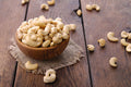 Cashews in a wooden bowl, whole raw cashew nuts