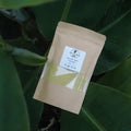 Baby bath powder sachet, off-white pouch with label