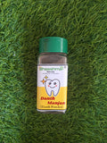 Tooth powder bottle with green cap, Bheeshma Danth Manjan label and tooth icon