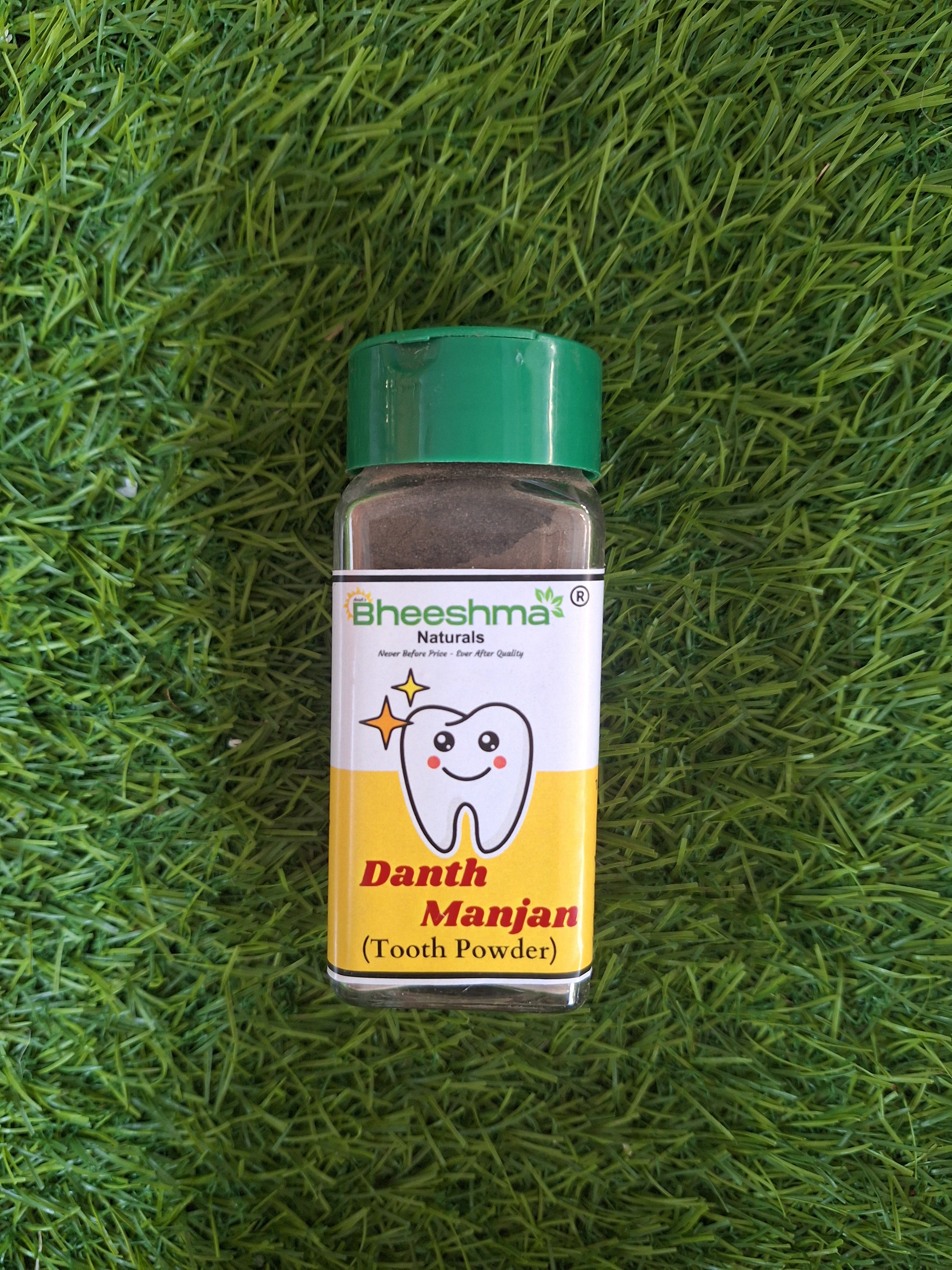 Tooth powder bottle with green cap, Bheeshma Danth Manjan label and tooth icon