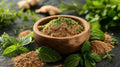 Tulasi holy basil powder in a wooden bowl, with fresh green leaves