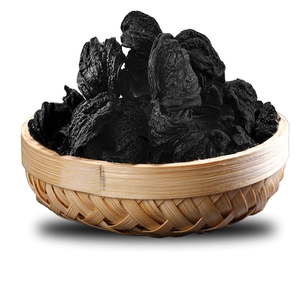 Dried dark tamarind fruits in woven wooden basket
