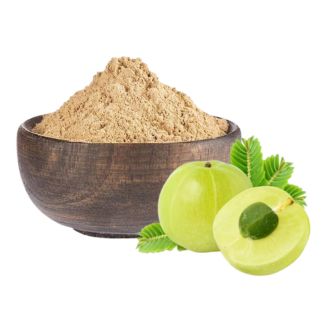Amla powder in wooden bowl with green amla fruit slices and leaves