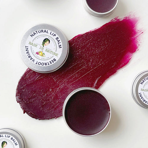 Natural lip balm tin with beetroot-colored balm swatch, round metal container.
