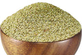 Browntop millet grains in a wooden bowl, pale green