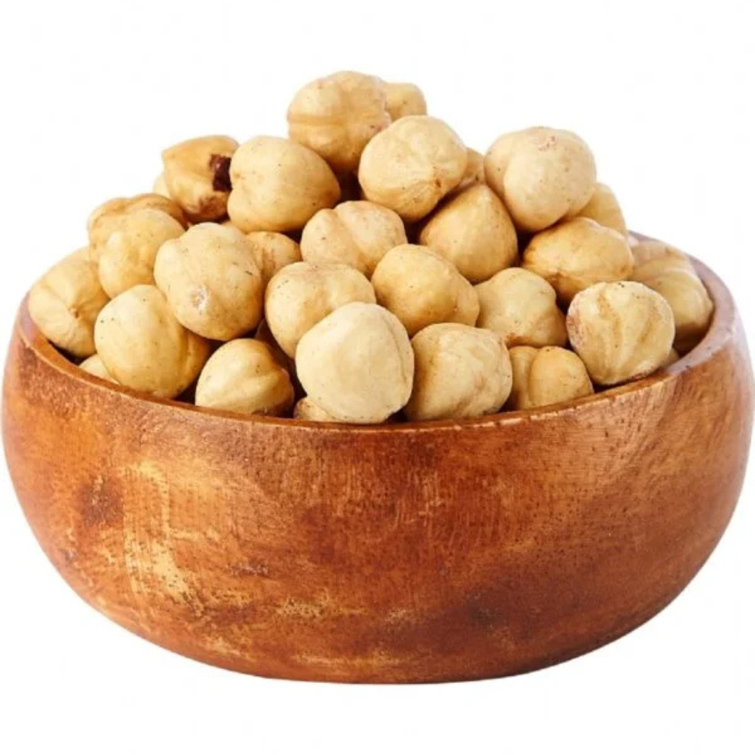 Hazelnuts in a wooden bowl, whole light brown nuts