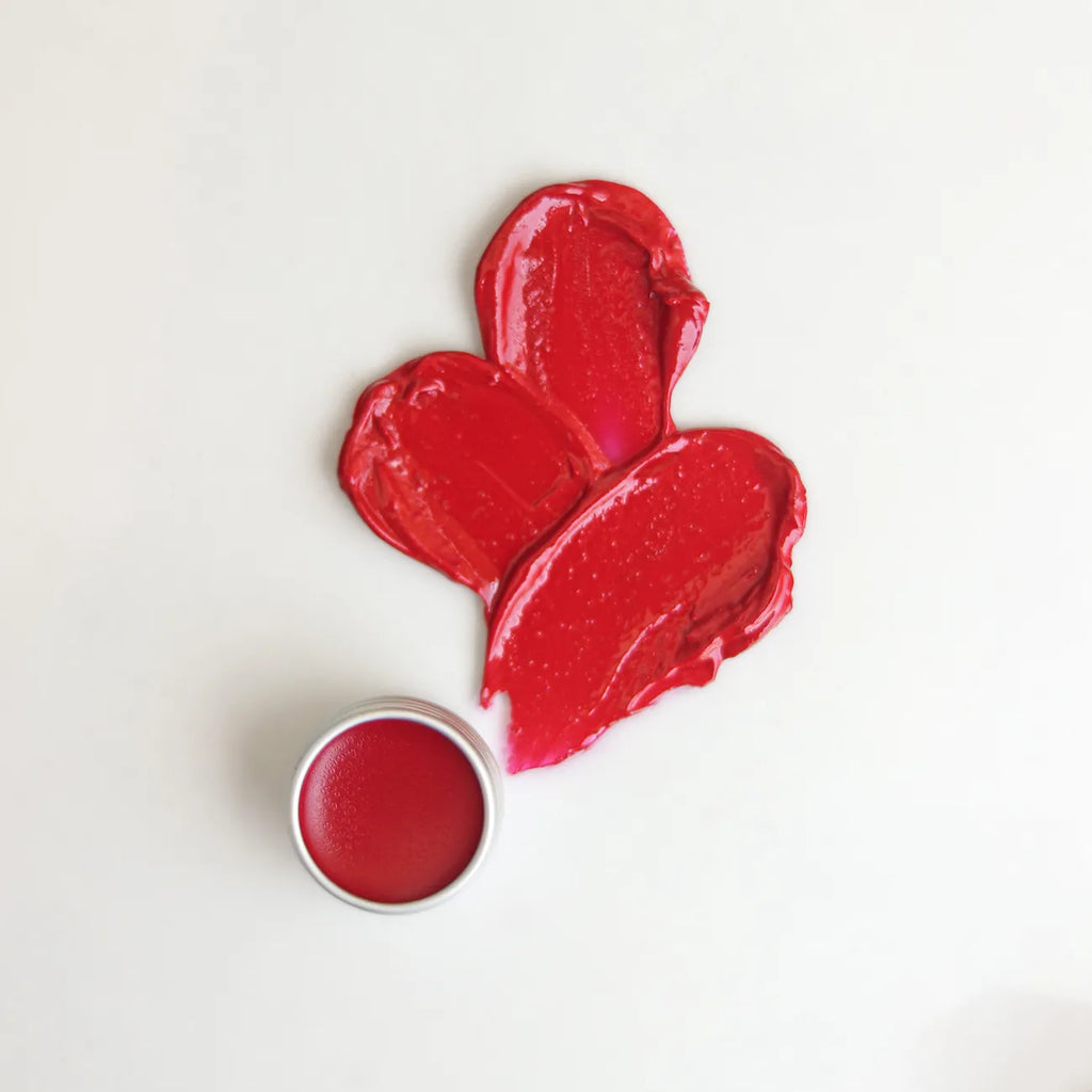 Hibiscus lip balm with red balm pieces and small open tin
