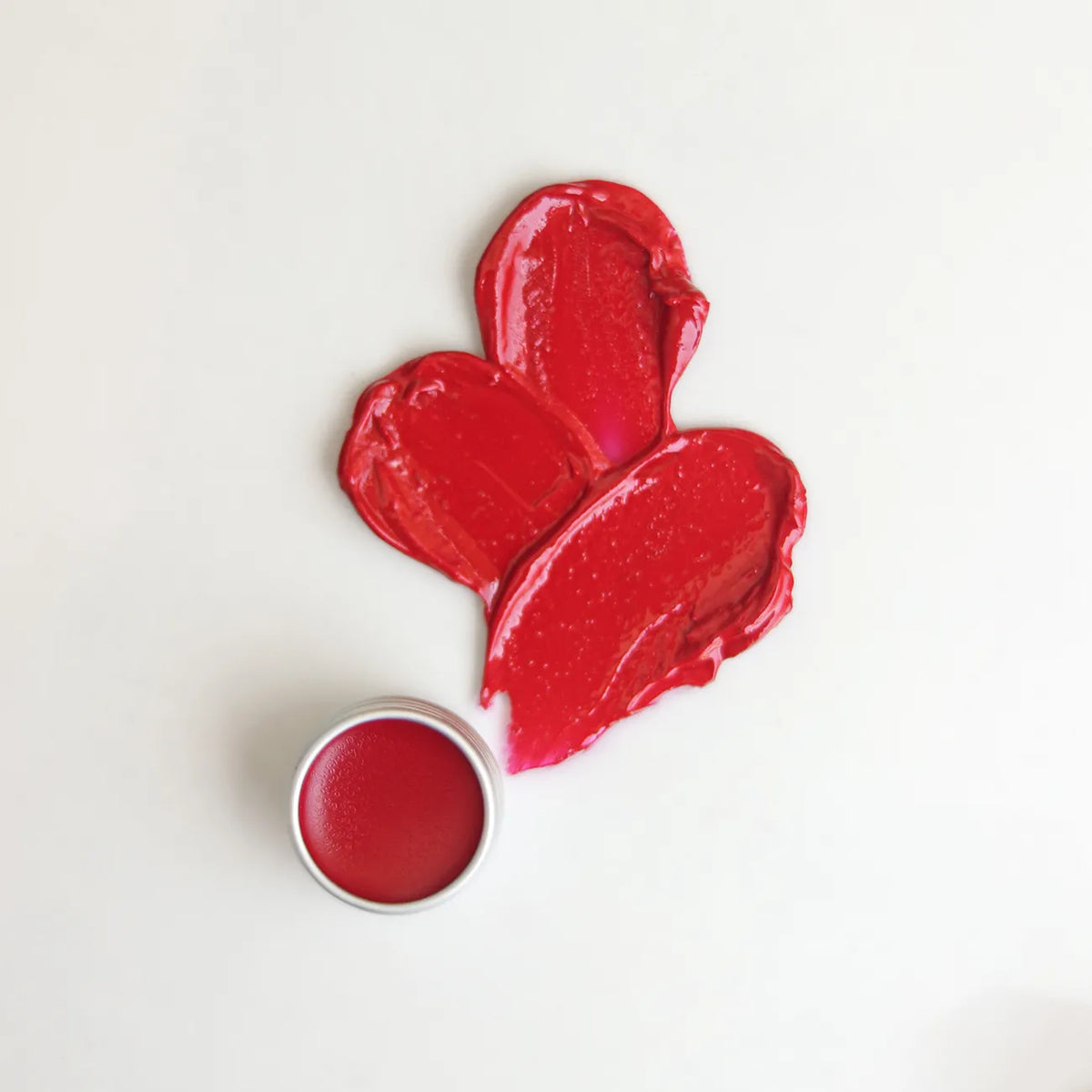 Hibiscus lip balm with red balm pieces and small open tin