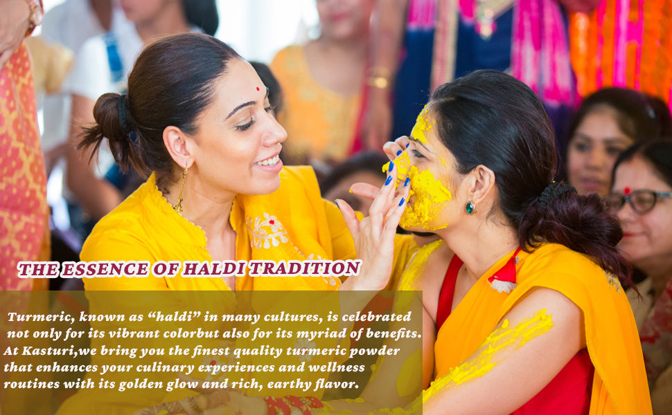 People smiling while applying turmeric-colored paste at a festive gathering