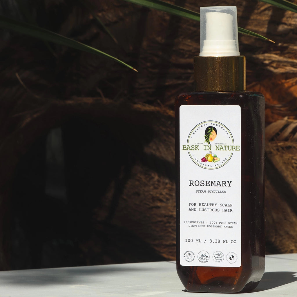 Rosemary hydrosol spray bottle with amber glass and white mist cap