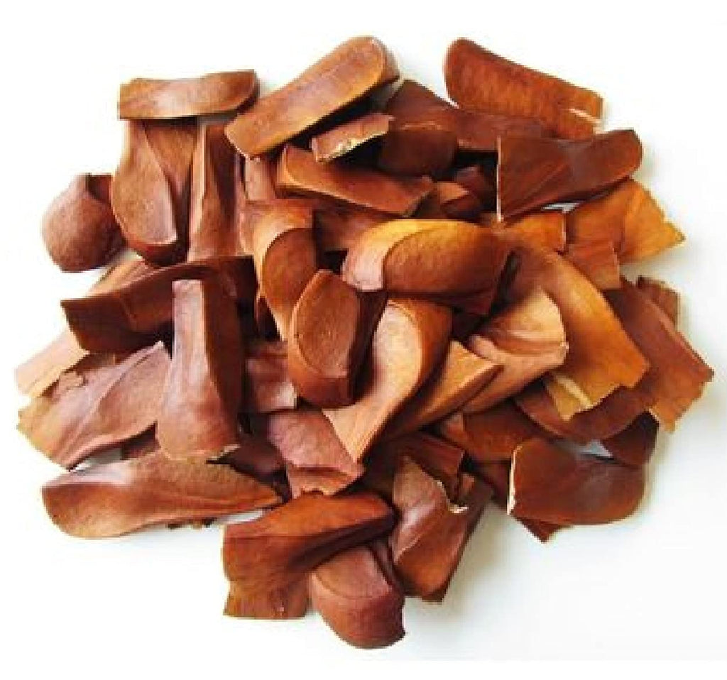 Pile of brown almond slices (kadwa badam) in rough chunks