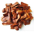 Pile of brown almond slices (kadwa badam) in rough chunks