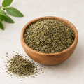 Stevia tea cut leaf in wooden bowl with loose dried green leaf pieces