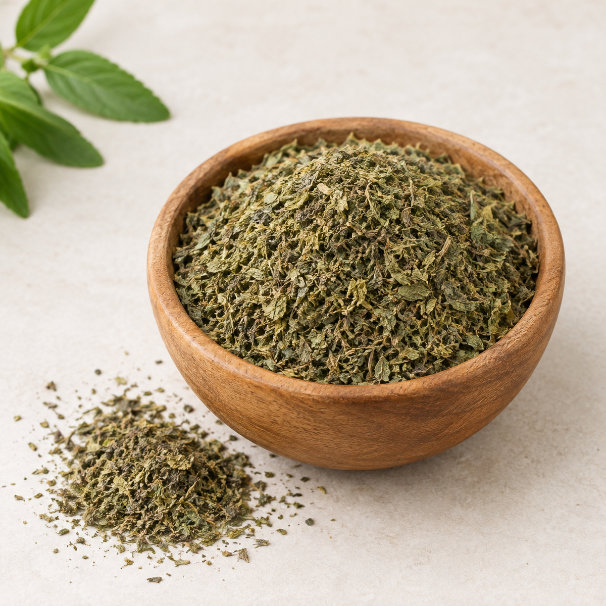 Stevia tea cut leaf in wooden bowl with loose dried green leaf pieces