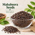 Mahabeera seeds in a glass bowl with scattered seeds and green leaves