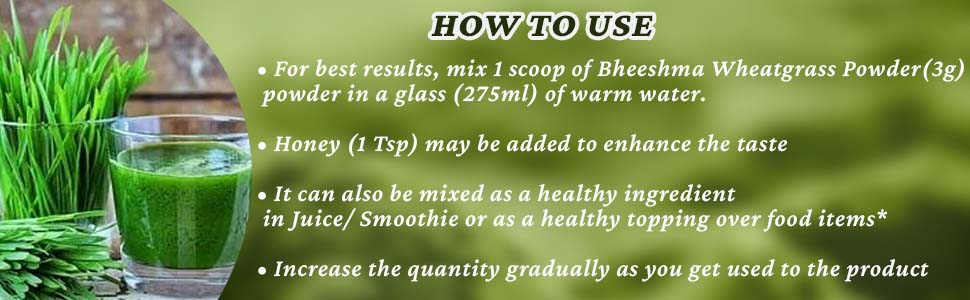 Wheat grass powder scoop shown with glass and fresh wheat grass blades.