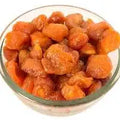 Dried orange plums in a bowl, chopped pieces