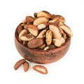 Brazil nuts in a small wooden bowl, whole kernels