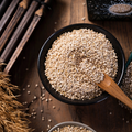Bowl of quinoa seeds with wooden spoon
