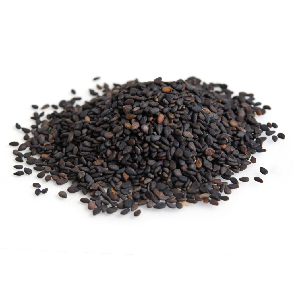 Black sesame seeds pile, small dark hulled seeds on white