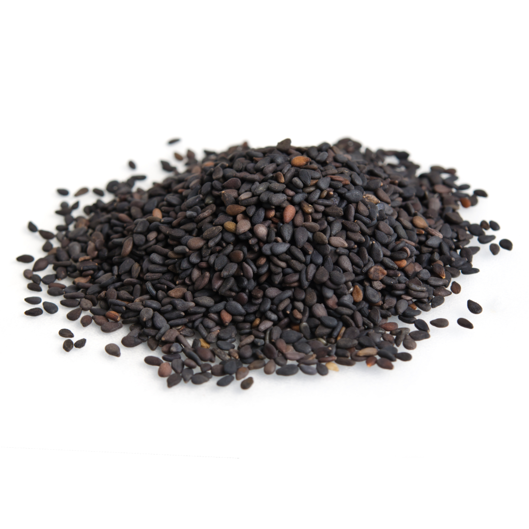 Black sesame seeds pile, small dark hulled seeds on white