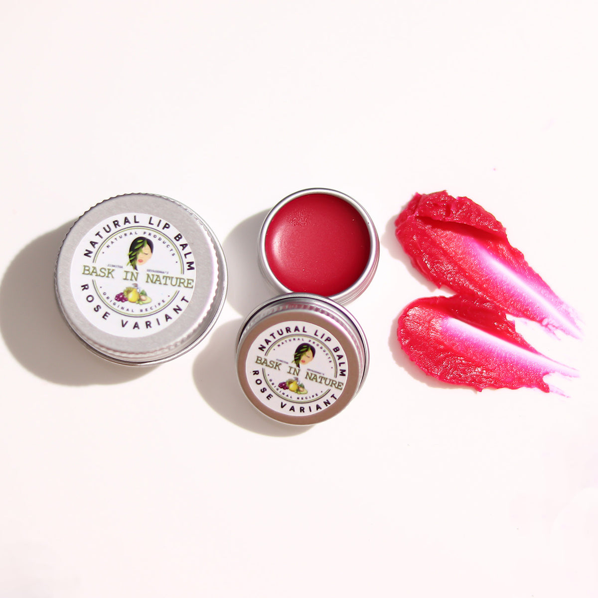 Rose lip balm tins with red balm lip smear, small round metal containers