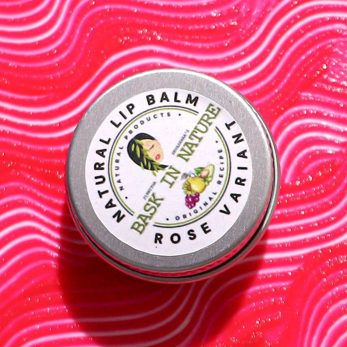 Rose lip balm tin lid, round metallic-gray container with rose label